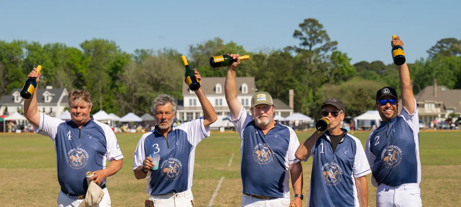 Blue team toasting after the 2026 Rose Hill Charity Polo Match in the South Carolina Lowcountry
